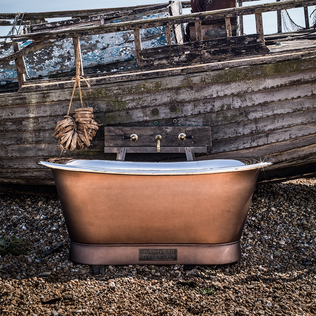 Freestanding Weathered Traditional Copper Bath with bath filler on standpipes