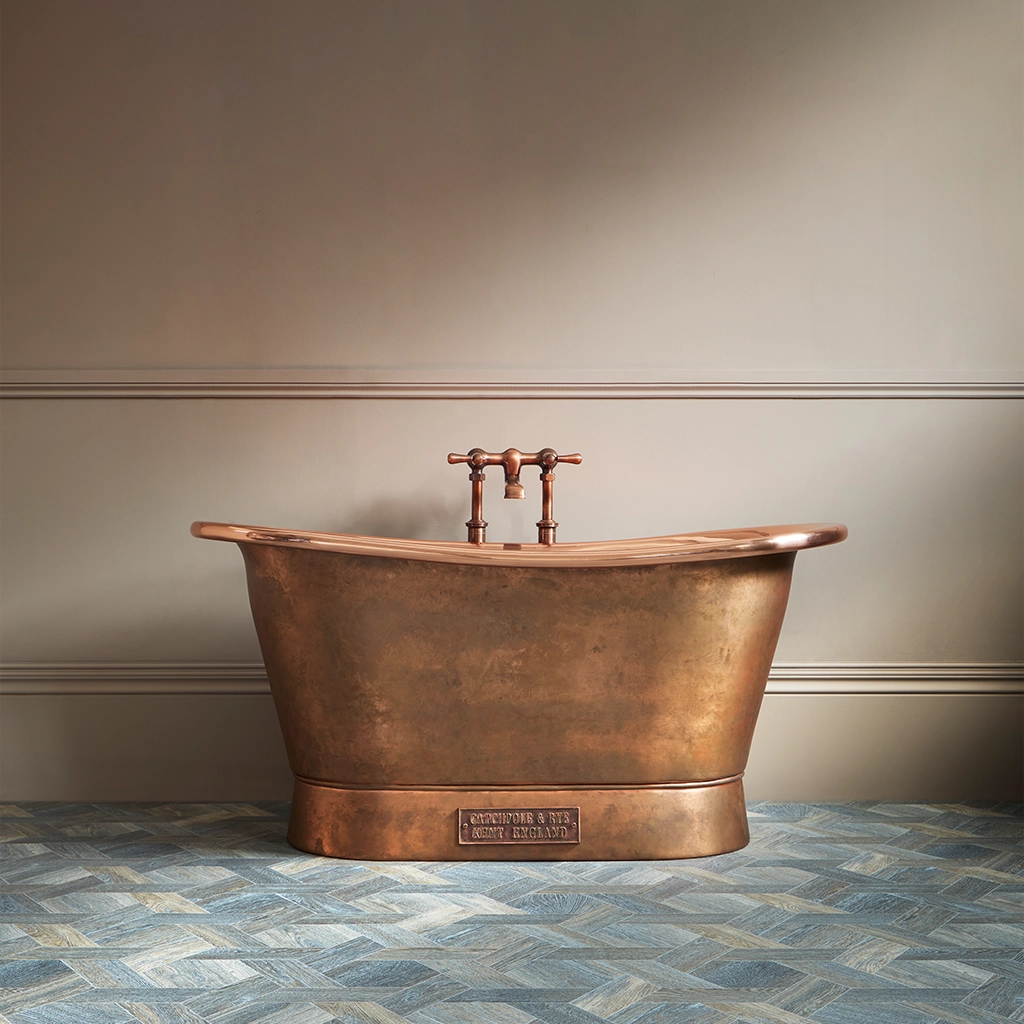 Freestanding Weathered Traditional Copper Bath with bath filler on standpipes