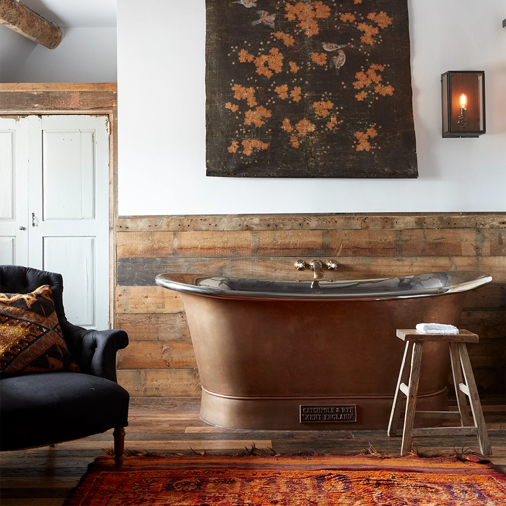 Freestanding Weathered Traditional Copper Bath with bath filler on standpipes