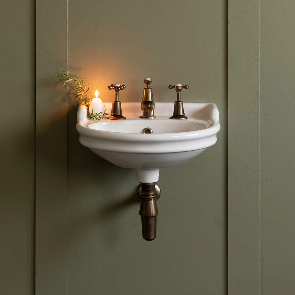 Ceramic cloakroom basin with overflow available in a number of brassware finishes
