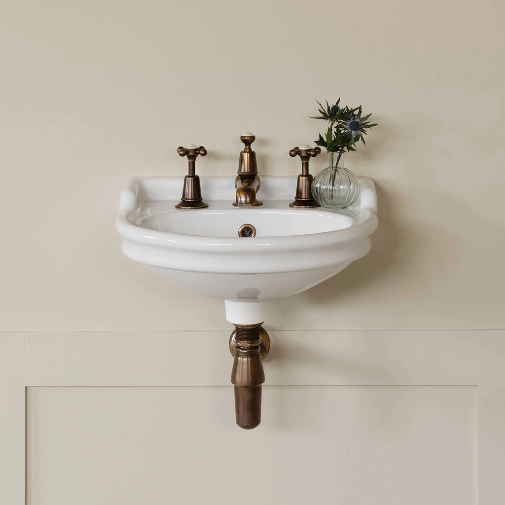 Ceramic cloakroom basin with overflow available in a number of brassware finishes