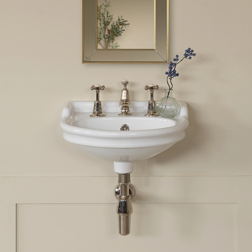 Ceramic cloakroom basin with overflow available in a number of brassware finishes