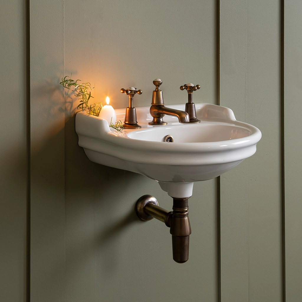 Ceramic cloakroom basin with overflow available in a number of brassware finishes