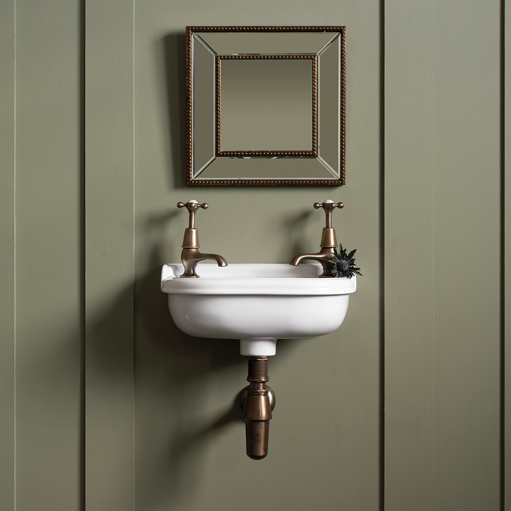 Ceramic cloakroom basin with overflow available in a number of brassware finishes