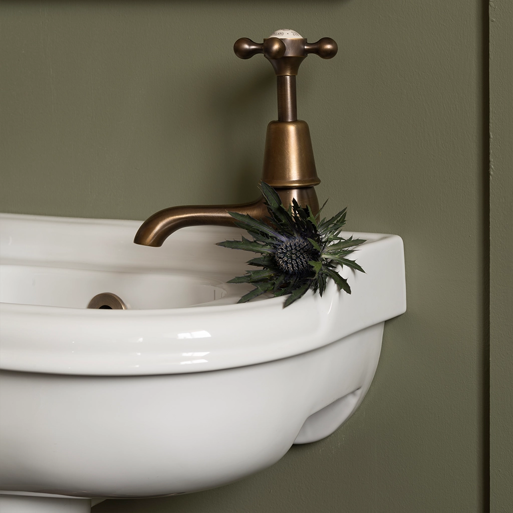 Ceramic cloakroom basin with overflow available in a number of brassware finishes