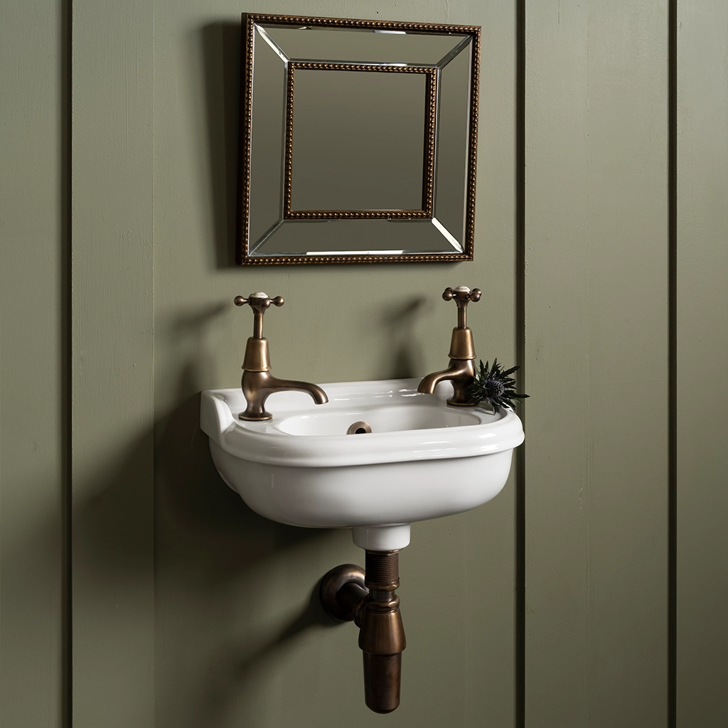Ceramic cloakroom basin with overflow available in a number of brassware finishes