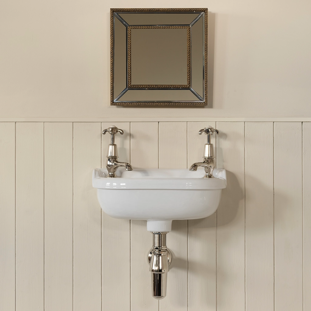 Ceramic cloakroom basin with overflow available in a number of brassware finishes