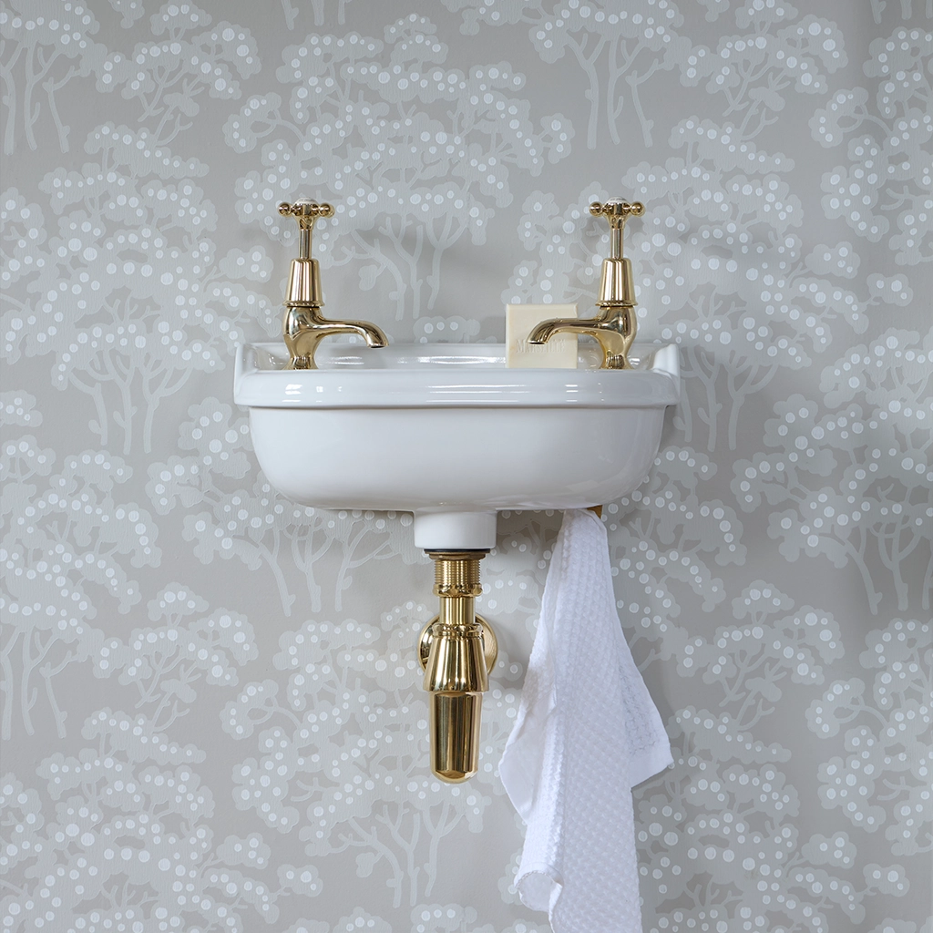 Ceramic cloakroom basin with overflow available in a number of brassware finishes