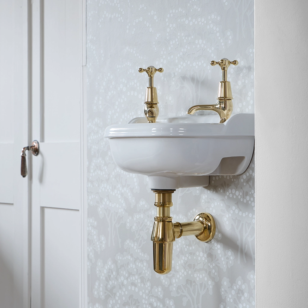 Ceramic cloakroom basin with overflow available in a number of brassware finishes