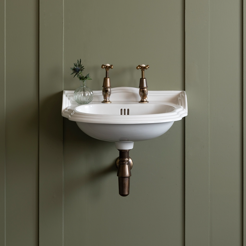 Ceramic cloakroom basin with overflow available in a number of brassware finishes