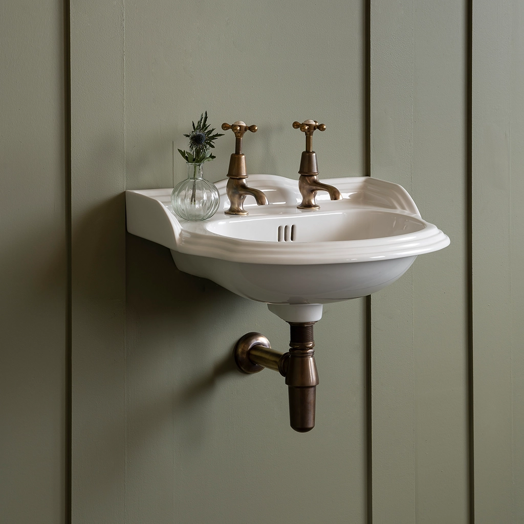 Ceramic cloakroom basin with overflow available in a number of brassware finishes