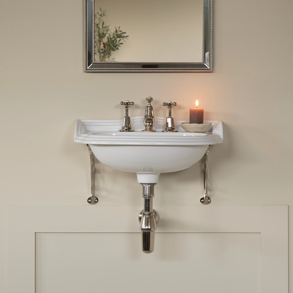 Ceramic cloakroom basin with overflow available in a number of brassware finishes