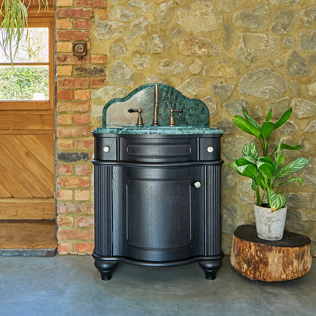 Single wooden vanity unit with amble bathroom storage and marble splashback