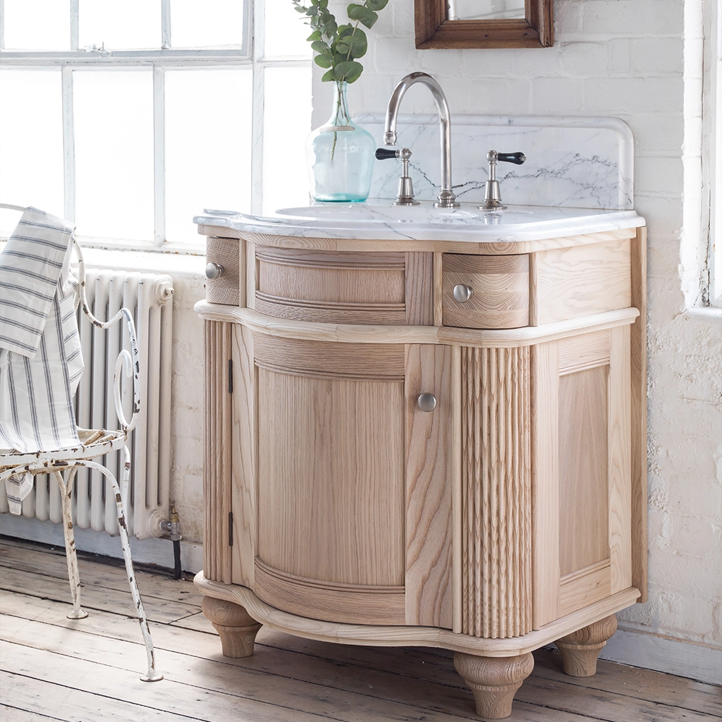 Single wooden vanity unit with amble bathroom storage and marble splashback