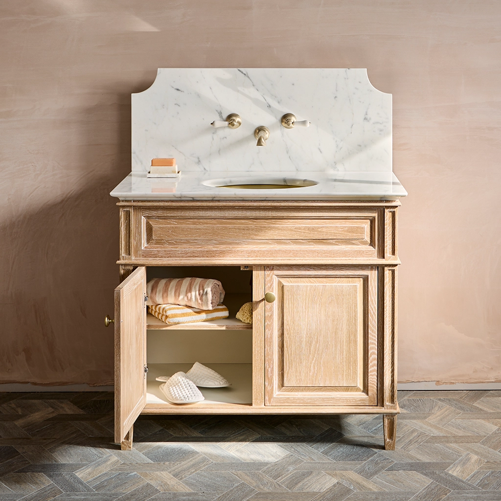 Single wooden vanity unit with amble bathroom storage and marble splashback