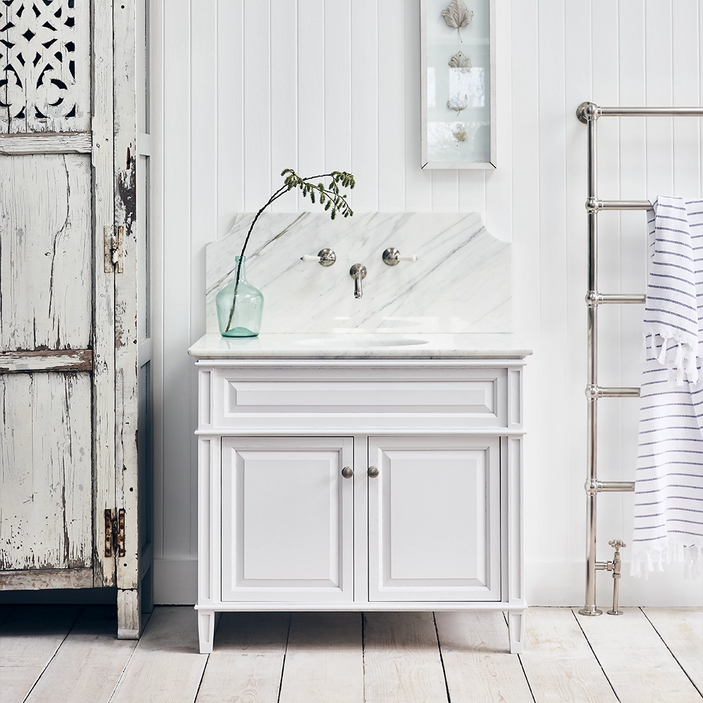 Single wooden vanity unit with amble bathroom storage and marble splashback