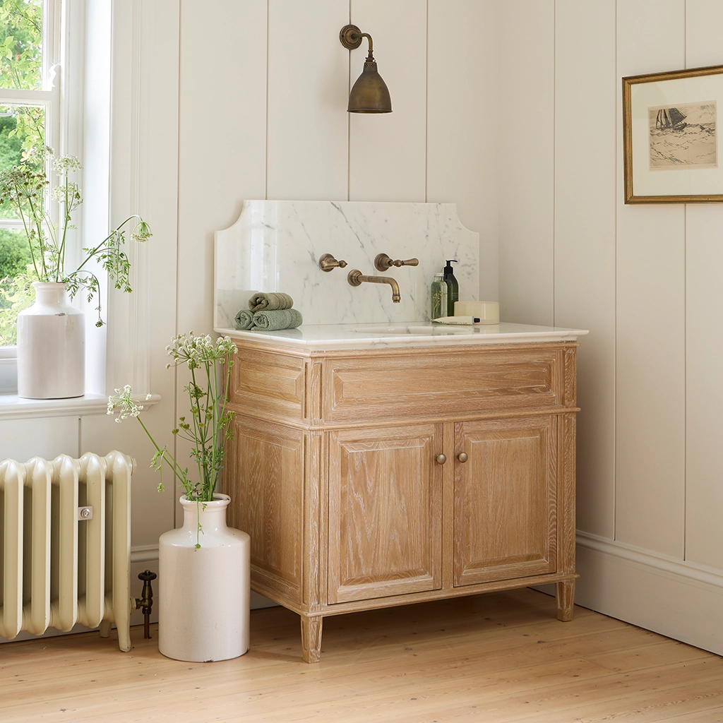 Single wooden vanity unit with amble bathroom storage and marble splashback