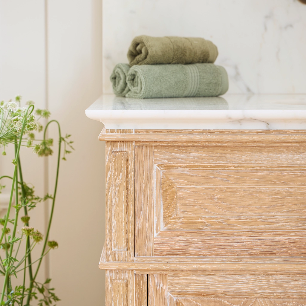 Single wooden vanity unit with amble bathroom storage and marble splashback